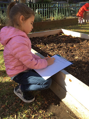 girl taking notes in the school garden