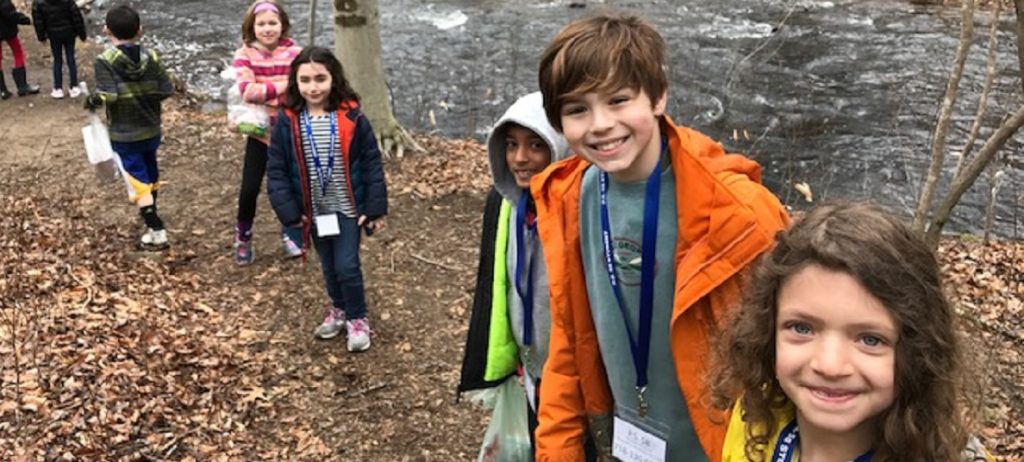 Students near stream during release of trout eggs